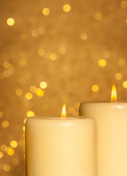 Candles with flame on golden bokeh — Stock Photo, Image