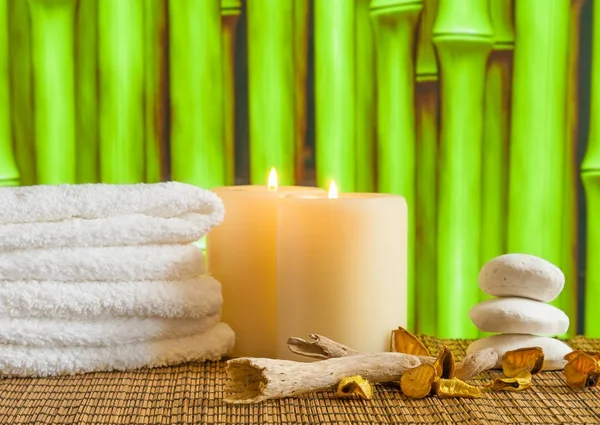 Spa massage border background with towel stacked, candles and stone — Stock Photo, Image