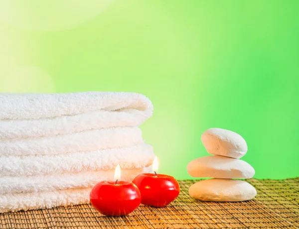 Spa massage border background with towel stacked,red candles and stone — Stock Photo, Image