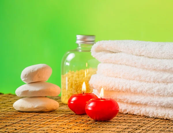 Spa massage bordure fond avec serviette empilée, bougies rouges et pierre — Photo