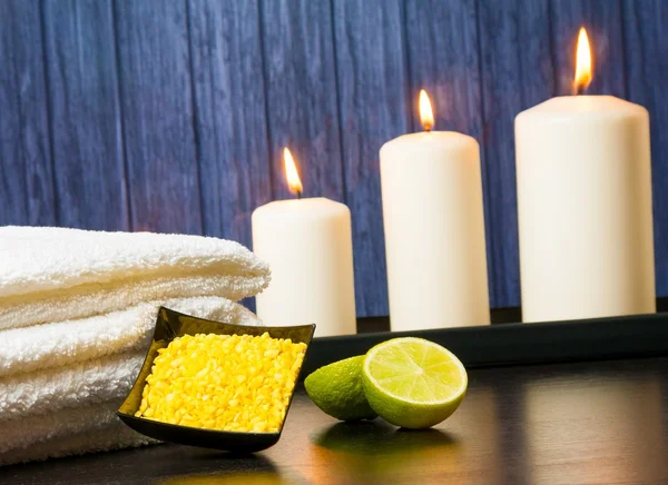 Spa massage gränsen bakgrunden med handduk staplade ljus sea salt och lime — Stockfoto