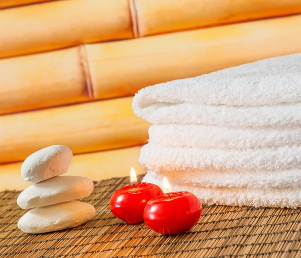 Spa massage border background with towel stacked stone and red candles — Stock Photo, Image