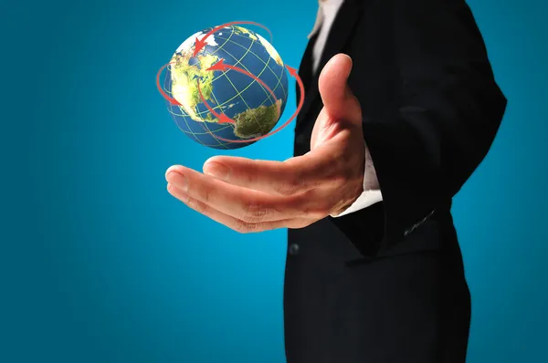 Businessman holds Earth in a hand — Stock Photo, Image