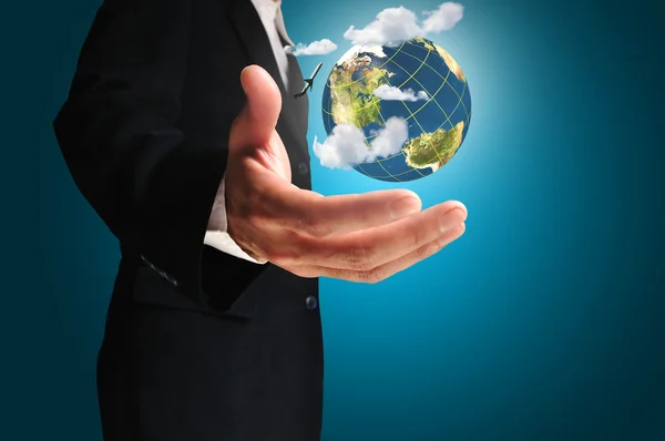 Businessman holds Earth in a hand — Stock Photo, Image