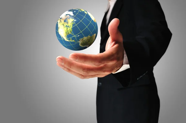 Businessman holds Earth in a hand — Stock Photo, Image