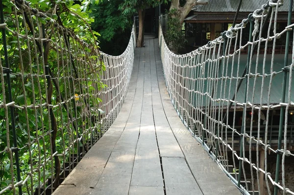 Suspension bridge across the water — Stock Photo, Image