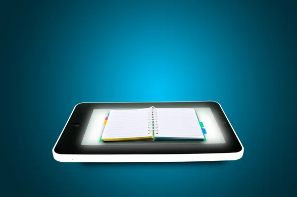 Black tablet pc with book or Diary on blue background. — Stock Photo, Image