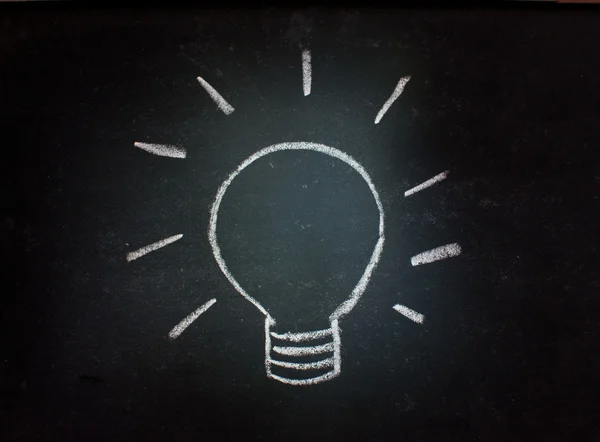 Lightbulb on a blackboard — Stock Photo, Image