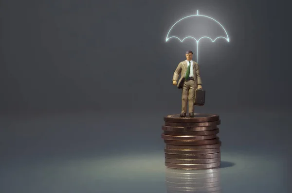 Miniature Man Standing Lit Umbrella Top Pile Coins — Stock Photo, Image