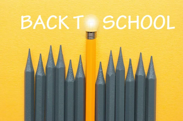 Back School Pencil Light Bulb Standing Out Amongst Grey Pencils — Zdjęcie stockowe