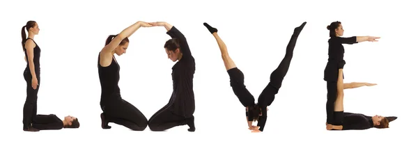 Black dressed people forming LOVE word over white — Stock Photo, Image