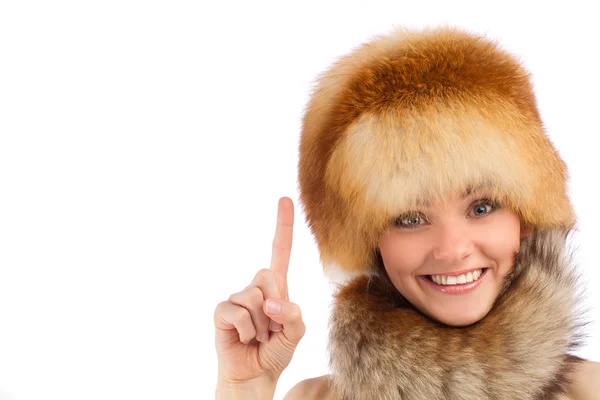 Close up portrait of young beautiful girl in fur hat showing finger up — Stock Photo, Image