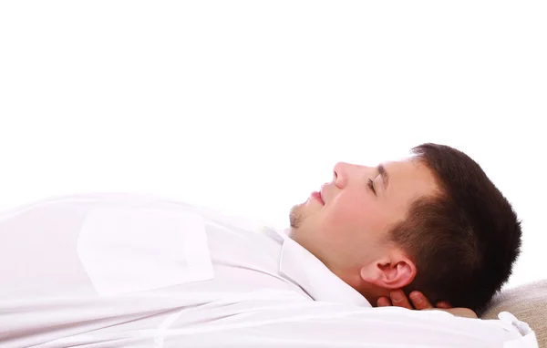 Young man dressed in a white shirt lying and looking up — Stock Photo, Image