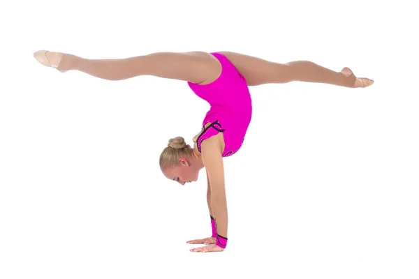 Beautiful girl gymnast staying in a handstand and doing split — Stock Photo, Image