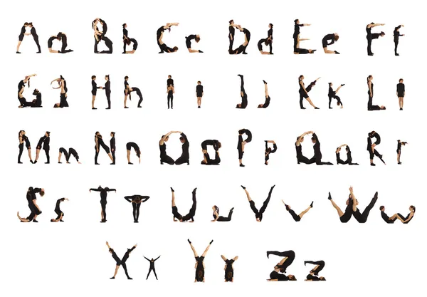 Groupe de personnes habillées noires formant les lettres de l'alphabet — Photo