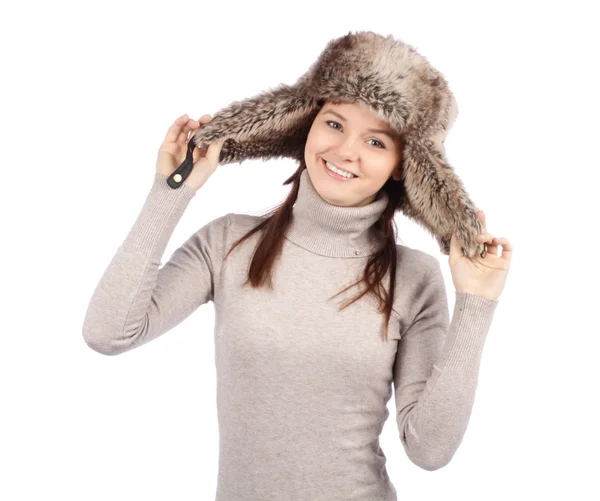 Attractive girl in a fur hat isolated on white — Stock Photo, Image