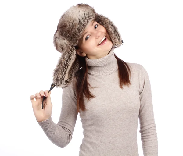 Attractive girl in a fur hat isolated on white — Stock Photo, Image