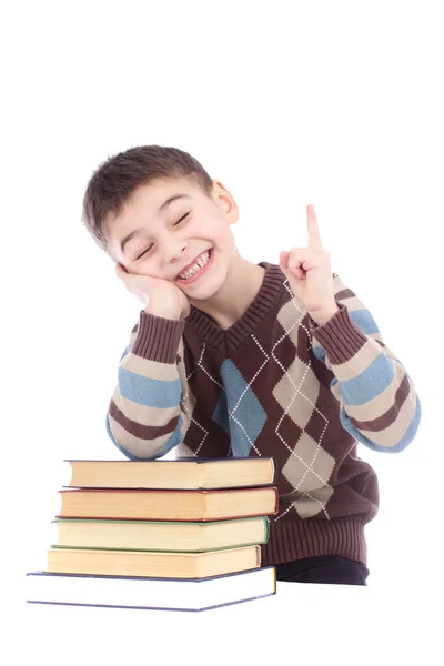Photo of young boy with books showing finger up isolated over white background — Stock Photo, Image
