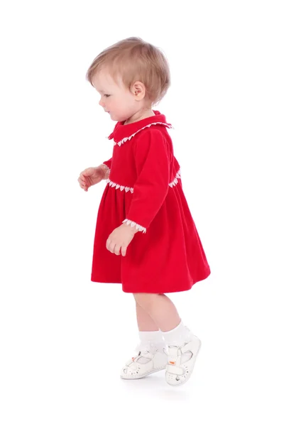 Jolie petite fille dans une robe courte rouge isolé sur fond blanc — Photo