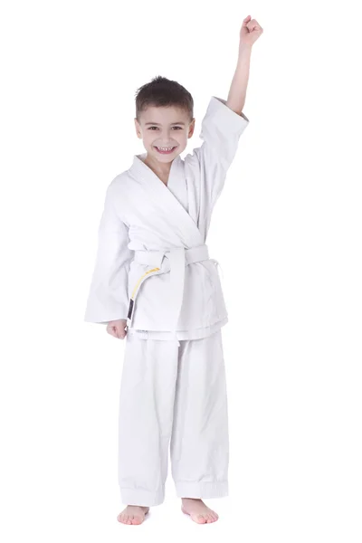 Young boy fighter in kimono with hand up isolated on white background — Stock Photo, Image