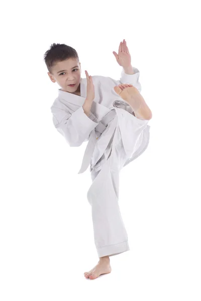 Young boy training kick isolated on white background — Stock Photo, Image