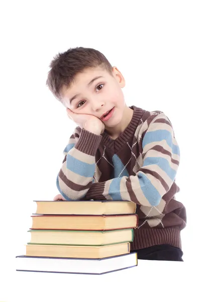 Мальчик с книгами на белом фоне — стоковое фото