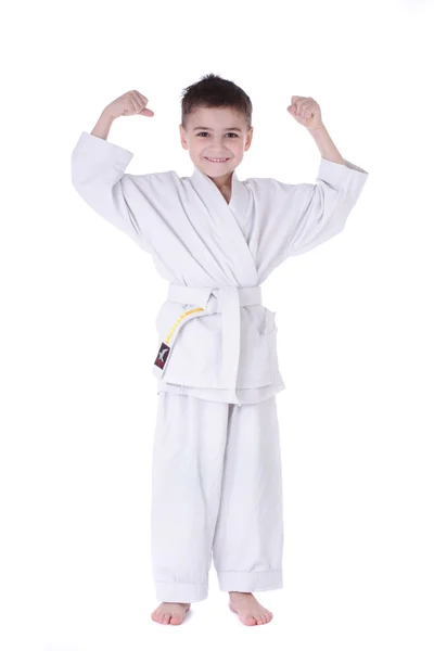 Young boy fighter in kimono with hand up isolated on white background — Stock Photo, Image