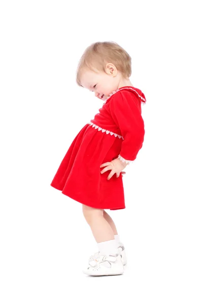 Vrij klein meisje in een rode korte jurk geïsoleerd op witte achtergrond — Stockfoto