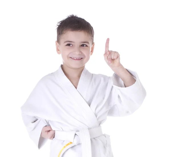 Young boy fighter in kimono with hand up isolated on white background — Stock Photo, Image