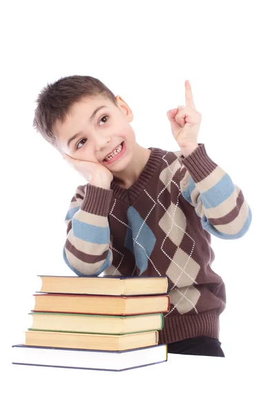 Photo of young boy with books showing finger up isolated over white background — Stock Photo, Image