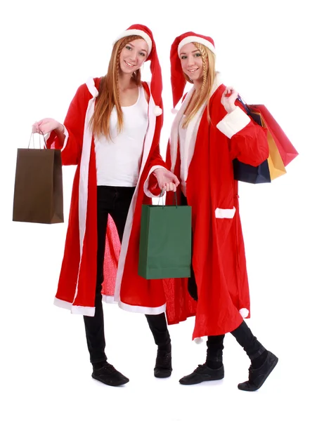 圣诞购物，两个女孩双胞胎穿着圣诞老人的帽子 — 图库照片