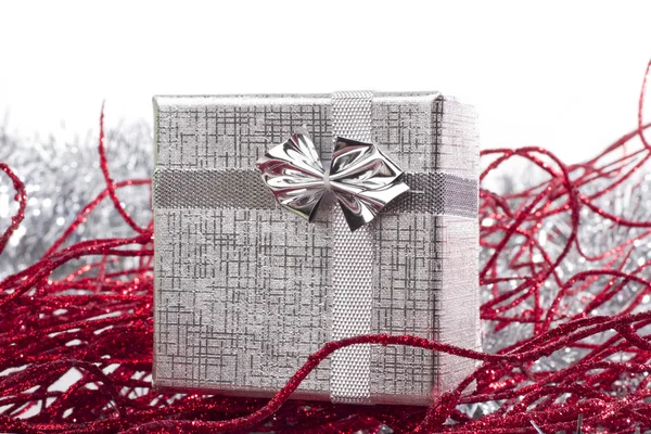 Silver gift in christmas decorations — Stock Photo, Image