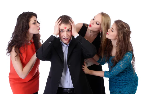 Young man with three girls and lipstick kiss-marks — Stock Photo, Image