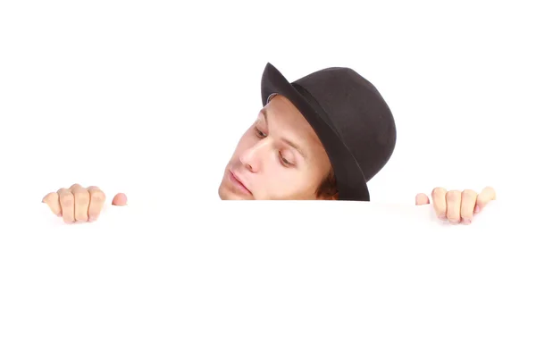 Teenage boy hiding behind a billboard and looking down — Stock Photo, Image