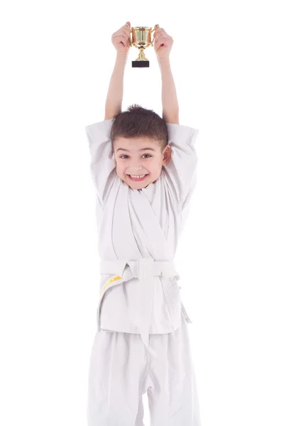 Young boy fighter winner in white kimono with cup — Stock Photo, Image