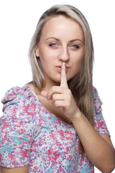 Pretty woman with finger on her lips Stock Image