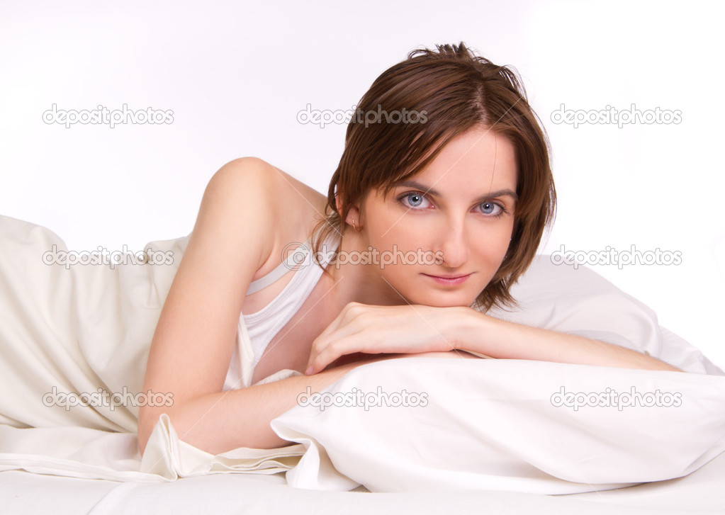 Attractive woman in bed looking on camera