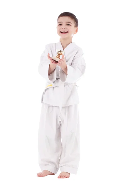 Young boy fighter winner in white kimono with cup — Stock Photo, Image