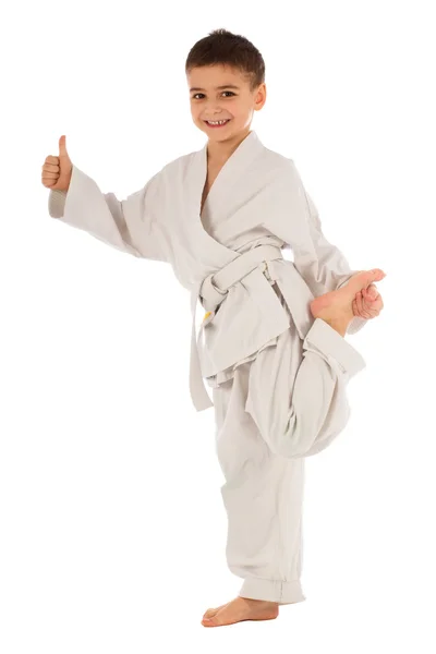 Young boy fighter in white kimono showing thumb up — Stock Photo, Image