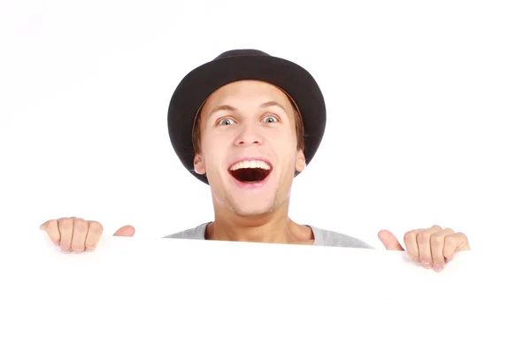 Teenage boy hiding behind a billboard — Stock Photo, Image