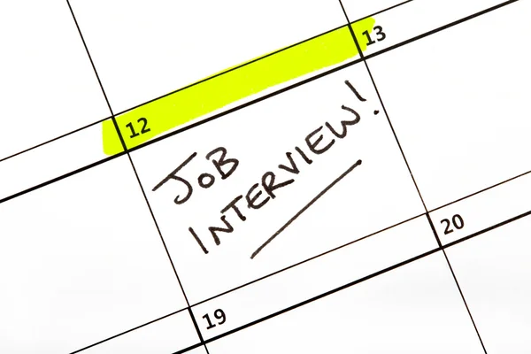 Job Interview Dato på en kalender - Stock-foto