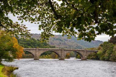 Dunkeld, İskoçya - 11 Ekim 2021: İskoçya 'nın güzel Dunkeld kasabasında Tay Nehri üzerinde uzanan Dunkeld Köprüsü manzarası.