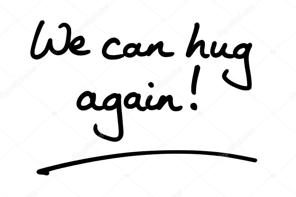 We can hug again! handwritten on a white background.