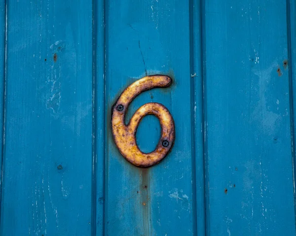 Close Rusty Number Plaque Screwed Blue Wooden Background — Stock Photo, Image