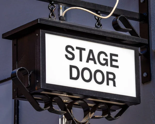 Close-up of a vintage Stage Door sign at a theatre.
