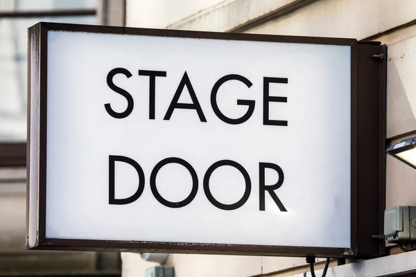 Close-up of a Stage Door sign at a theatre.