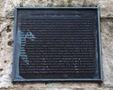 London, UK - March 17th 2022: An information plaque on the base of the Monument to the Great Fire of London, in the City of London, UK.