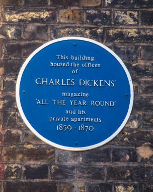 London, UK - March 17th 2022: A blue plaque on Wellington Street in central London, UK, marking the location of the offices of the magazine All Year Round by Charles Dickens.