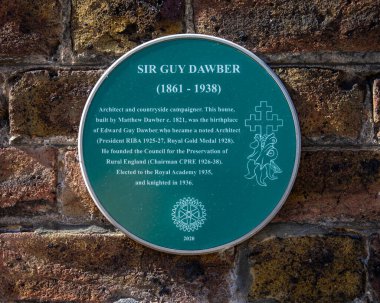 Norfolk, UK - April 8th 2022: A plaque on the exterior of a building in Kings Lynn, Norfolk, UK, detailing information about the architect Sir Guy Dawber who was born in the house.