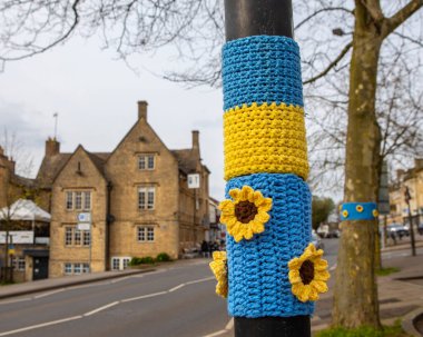 Close-up of a knitted piece in support of Ukraine, on a lamp post in the historic market town of Chipping Norton in Oxfordshire, UK.